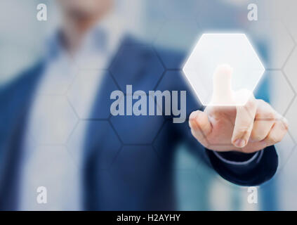 Person touching an hexagonal button on a digital interface. Concept about technology and choices Stock Photo