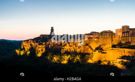 Town on hill, illuminated at dusk, Pitigliano, Tuscany, Italy Stock Photo
