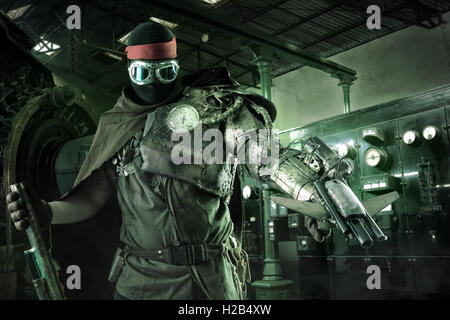 Futuristic soldier posing with gun and armor Stock Photo