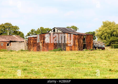 Rusty corrugated iron old farm buildings Cheshire England UK Stock Photo