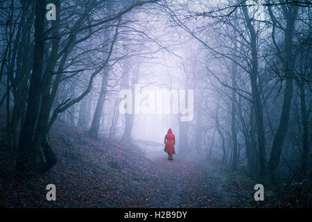 alone woman in dark forest Stock Photo