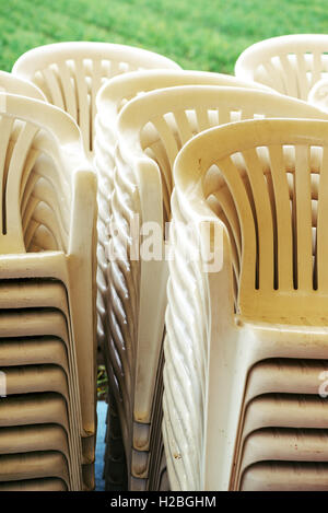 Stacked plastic chairs outdoors, selective focus detail Stock Photo