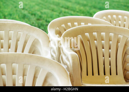 Stacked plastic chairs outdoors, selective focus detail Stock Photo