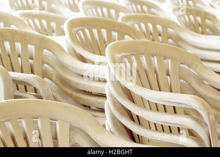 Stacked plastic chairs outdoors, selective focus detail Stock Photo