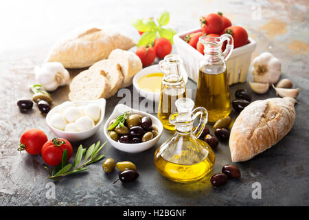 Olive oil in vintage bottles and italian cuisine ingredients Stock Photo