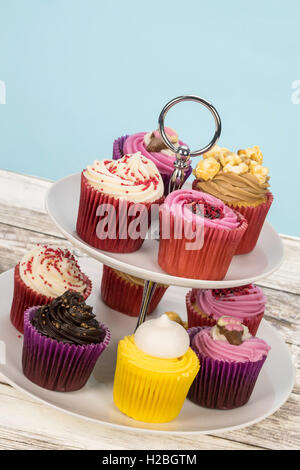 An assortment of decorated cupcakes on a cake stand - tilted shot Stock Photo