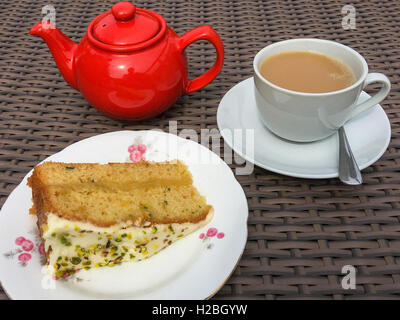 Slice of sponge cake with a pot of tea. Stock Photo