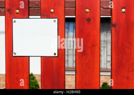 Red wooden fence with empty number plate Stock Photo