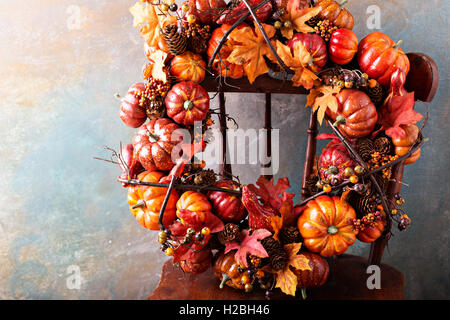 Festive autumn wreath with pumpkin and fall leaves Stock Photo