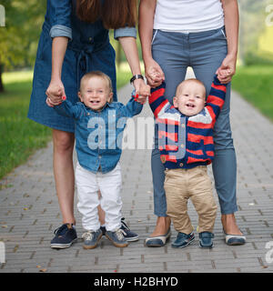 mothers holding sons by hand Stock Photo