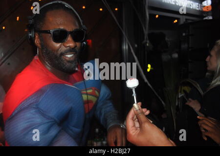 Idris Elba performing a DJ set at the Box Park being handed halloween candy Stock Photo