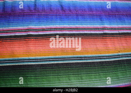 Texture: South American hand made colorful fabric with traditional patterns of stripes & design, Antigua, Guatemala. Stock Photo
