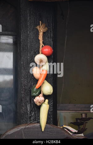 Traditional Guatemalan dry vegetables hanging the column of a restaurant in Antigua, Guatemala Stock Photo