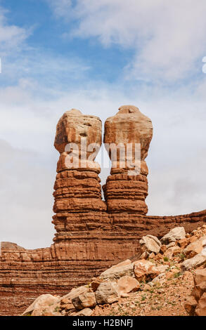 The Twin Rocks of Bluff, showing geological rock layers, under a blue sky with clouds, Utah, USA. Stock Photo