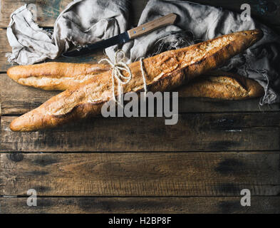 French baguettes on rough rustic wooden background Stock Photo