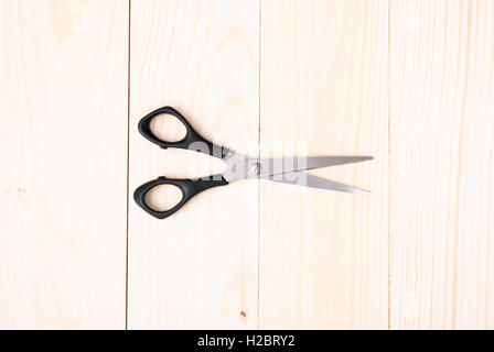 Scissors on wooden background Stock Photo