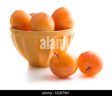 Ripe yellow plums in bowl isolated on white background. Stock Photo