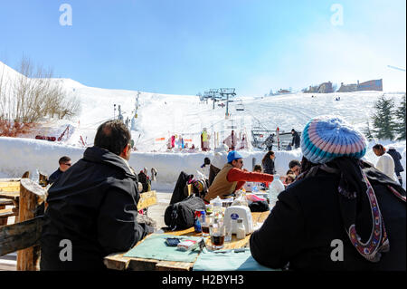 People having lunch at a restaurant terrace in Mzaar Kfardebian ski resort, ex-Faraya ski resort, Lebanon, winter in Middle East Stock Photo