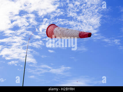 Windsock on the cloudy blue sky Stock Photo