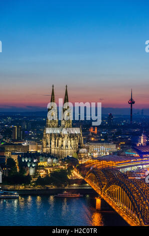 River Rhine at dusk, looking towards Cologne Cathedral with the Hohenzollern Bridge in the foreground, Cologne, Germany Stock Photo