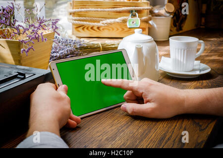 Business man works on tablet pc in cafe Stock Photo