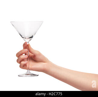 Close up of female hand holding empty clean transparent martini glass against white background. Clipping path for glass border Stock Photo