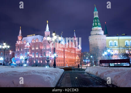 An alley at the Manege square (Manezhnaya ploshchad) in Moscow at a winter evening with snowdrifts on its sides Stock Photo