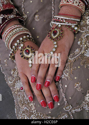 Asian wedding hands and jewelery, henna and gold