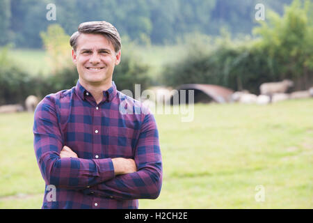 Portrait Of Dairy Farmer In Field With Cattle Stock Photo - Alamy
