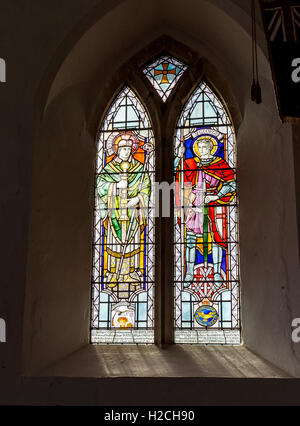 Stained glass window dedicated to the dead of two world wars in St Peter's Westleton, a 14th century thatched church in Suffolk Stock Photo