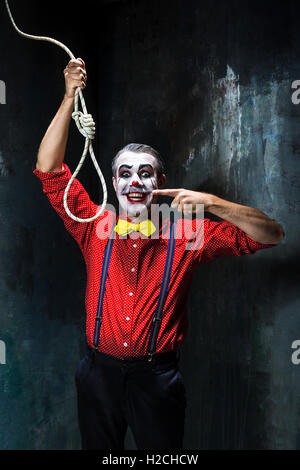 Hanging Rope Creepy The scary clown and rope for hanging on dack background. Halloween ...