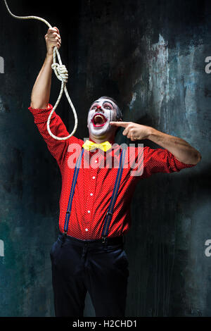 Hanging Rope Creepy The scary clown and rope for hanging on dack background. Halloween ...