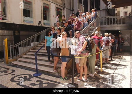 Tourists queueing at base of Elevador de Santa Justa Lisbon Portugal Stock Photo
