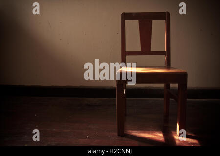 Vintage old wooden chair in grungy interior Stock Photo