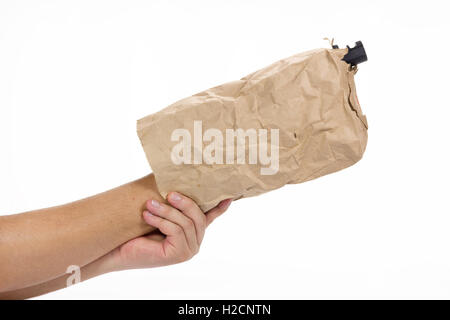 hand holding gun in the paper bag on white background Stock Photo