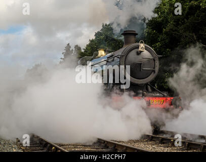 Railway locomotive enveloped in steam at Toddington station Stock Photo