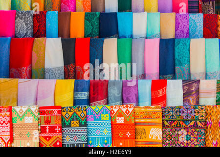 Row of colourful patterned fabrics for sale, Sang Ha, Louangphabang, Laos Stock Photo