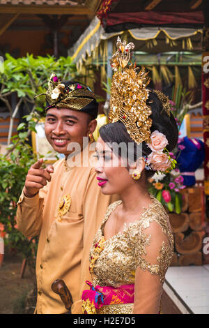Indonesia, Bali, Susut, Bridegroom and Bride posing for wedding reception pictures Stock Photo