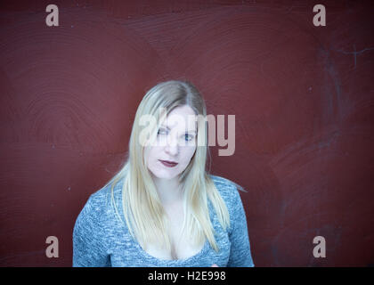 Young blonde woman outdoors in an urban environment Stock Photo