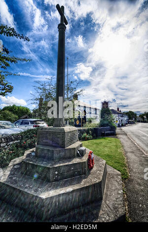 The Memorial beside the main road of Eardisland, Herefordshire beside an old restored AA phone box. Stock Photo