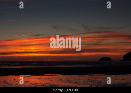 Colourful sunset over the beach at Polzeath, Cornwall Stock Photo