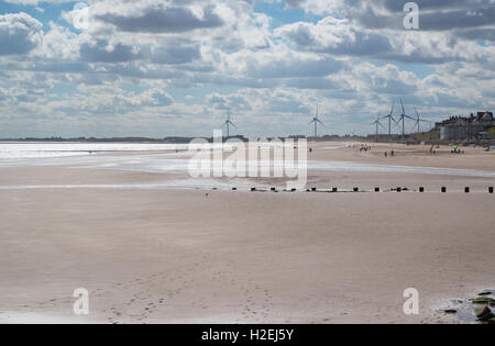 Wind power - Wind turbines in the distance Bridlington Beach - East Riding of Yorkshire Stock Photo