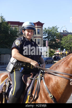 Female NYPD police officer on horseback patrolling Prospect Park, Brooklyn, New York. Stock Photo