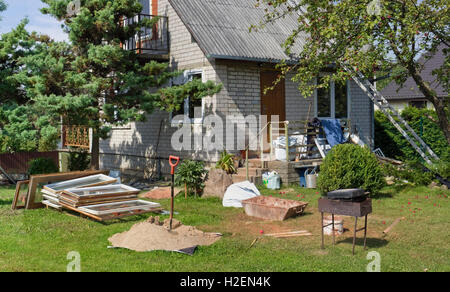 VILNIUS, LITHUANIA - AUGUST 21, 2016: Reconstruction of the rural house, replacement of old windows by modern plastic. It is the Stock Photo