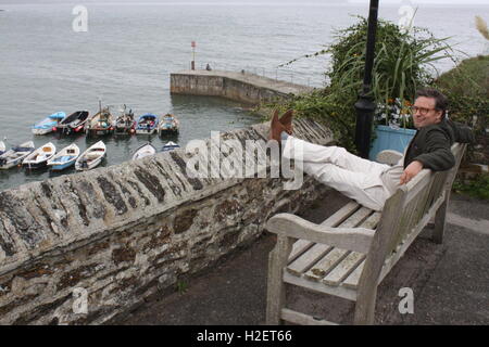 Cornwall, UK. 12th Sep, 2016. Actor Daniel Aichinger sitting at the coast of Portscatho during a break from the shooting of the Rosamunde Pilcher series for ZDF television in Cornwall, England, 12 September 2016. PHOTO: PHILIP DETHLEFS/dpa/Alamy Live News Stock Photo