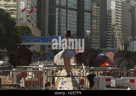October 13, 2014 - A young woman stand guard and watch for police moves at the furthest border of the ''˜Occupied Zone' in the Hong Kong's financial hub Central, during [Occupy Central-Umbrella Revolution]. Tomorrow September 28 marks the 2nd anniversary of the Umbrella Revolution. ( file photo ) Oct 13, 2014. Hong Kong. Liau Chung Ren/ZUMA © Liau Chung Ren/ZUMA Wire/Alamy Live News Stock Photo