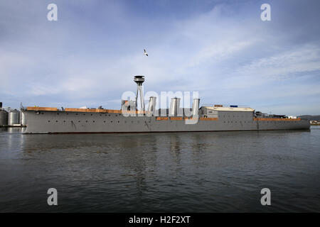 Belfast, Northern Ireland. 28th October, 2016. World War One Battle of Jutland veteran light cruiser, the 3,700-ton HMS Caroline is  moved from its current location in Alexandra Dock to Harland and Wolff Heavy Industries’ Belfast Dock for a scheduled hull inspection and repair, Friday, October 28, 2016. Two tug boats towed the ship from its moorings to the Belfast Dock at the mouth of the harbour. This is her first docking for almost three decades and a maritime event to be matched only by her return journey anticipated to be before Christmas. Credit:  Irish Eye/Alamy Live News Stock Photo