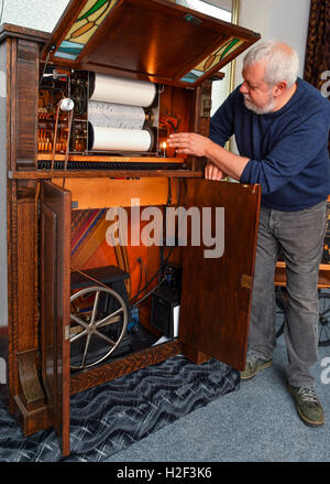 Thomas Jansen presenting a self-playing roller piano from 1900 in his Music Museum in Beeskow, Germany, 24 October 2016. PHOTO: PATRICK PLEUL/dpa Stock Photo