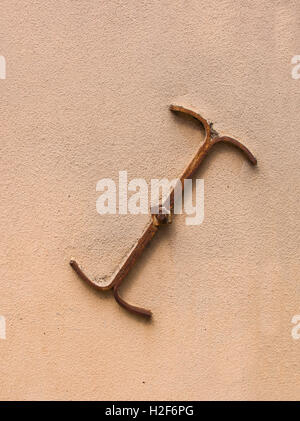 anchor plate or wall washer on a plastered wall of a medieval house Stock Photo