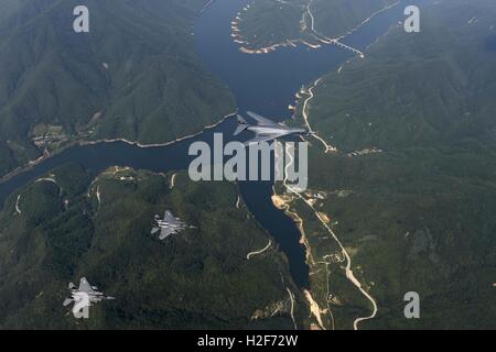 U.S. Air Force B1-B stealth strategic bomber and escort F-15 fighter aircraft fly close to the border between the Republic of Korea and North Korea September 21, 2016 in South Korea. Stock Photo